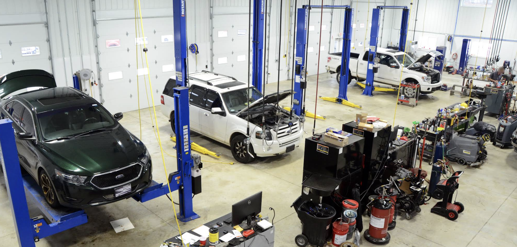 LaVerne's Repair shop floor with vehicles on lifts